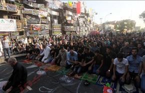 بالصور.. صلاة ودموع وشموع في موقع تفجير الكرادة