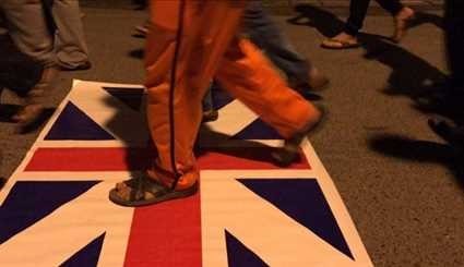 بالصور؛ محتجون يحرقون علم بريطانيا رفضا لزيارة ماي للبحرين
