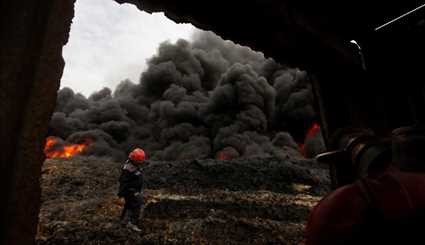 Iraqi Firefighters Extinguish Burning Oil Well