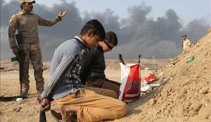 Iraqi Firefighters Extinguish Burning Oil Well