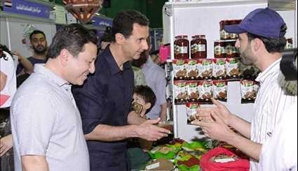 Assad Visits Exhibition, Takes Selfies with Syrians