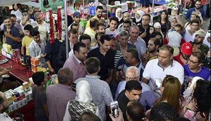 Assad Visits Exhibition, Takes Selfies with Syrians