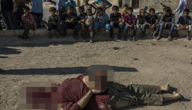 Terrorists behead pro-gov't Syrians in front of children