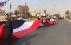 بالصورة.. علم عراقي يغطي نصف كيلومتر من شارع وسط بغداد