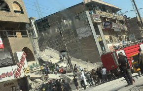 بالصور..انهيار مبنى بالكامل في بغداد
