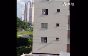إحذر.. فيديو مروع لطفل يقف خارج نافذة مبنى شاهق