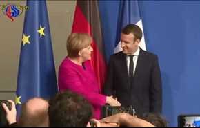 شاهد بالفيديو: هكذا أحرج ماكرون ميركل امام العدسات في أول لقاء بينهما!