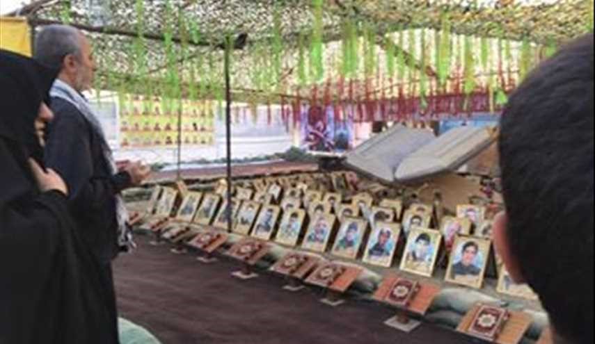 بالصور ..معرض لصور شهداء القوات العراقية على طريق النجف -كربلاء