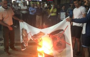 بالصور: متظاهرون بجنوب الضفة يحرقون صور ملك البحرين