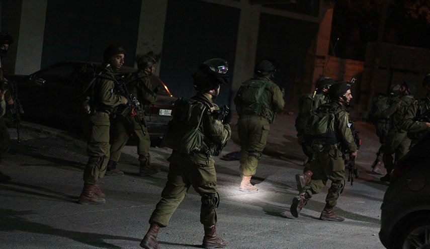 الاحتلال يعتقل 16 فلسطينيا من الضفة ويغلق طريق رام الله الجلزون
